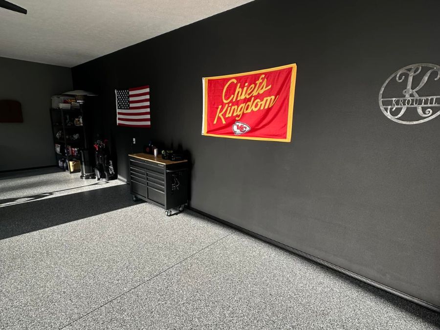 Mancave garage floor coating Missouri — dark flake polyaspartic system Ozarks Concrete Coatings